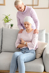 Young woman after chemotherapy with her mother at home. Stomach cancer concept