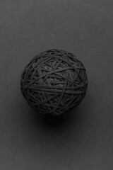 Black rubber band ball on a black background