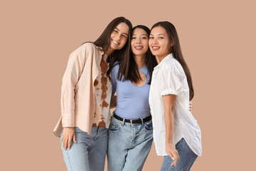 Young women hugging on beige background. Hen Party