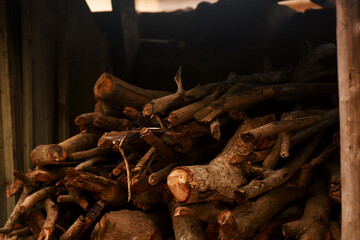 Wood cut down and stored in a pile in an outdoor store