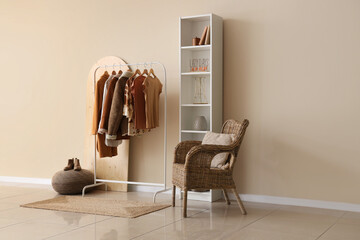 Rack with stylish female clothes in interior of modern room
