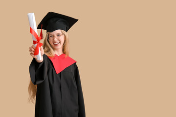 Female graduating student in mortar board with diploma on brown background