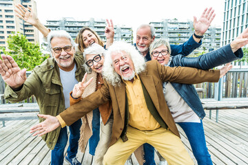 Happy group of senior people smiling at camera together outside - Delightful older friends enjoying...