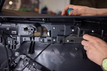 An automotive speaker is installed in a car door for audio equipment