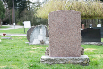 Large blank tombstone in cemetery with space for message.