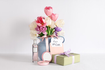 Card with text FOR MOM, beautiful tulips, gift box and bottle of perfume on white background. Mother's Day celebration