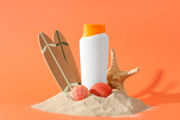 Composition with heap of sand, sunscreen cream and decor on color background