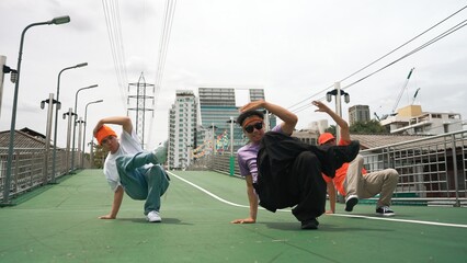 Group of professional break dancer dancing together or moving to hip hop music. Low angle camera of...