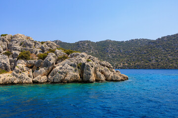 View of the rocky shore from the sea. Mediterranean Sea in Turkey. Popular tourist places. Background