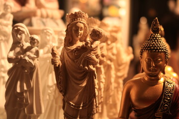 statue of buddha and infant mary