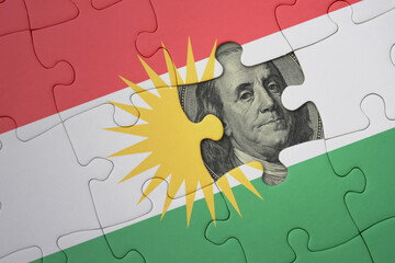 puzzle with the national flag of kurdistan and usa dollar banknote. finance concept