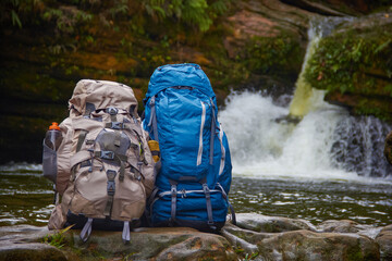 Travel backpacks in the waterfall 