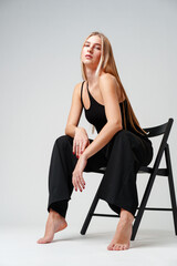 Young Woman Sitting on Chair Posing for Picture