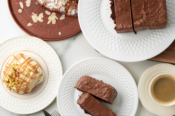 Homemade desserts sponge cake and cinnamon bun on table