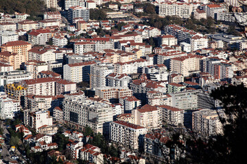 Obraz premium The tourist town of Budva in Montenegro from an aerial view. View on the roofs of houses. Horizontal.