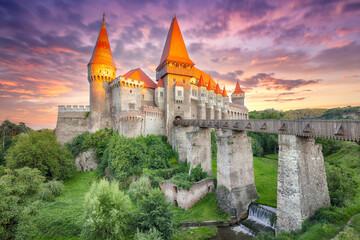 Fabulous evening view of Hunyad Castle / Corvin's Castle with wooden bridge at sunset