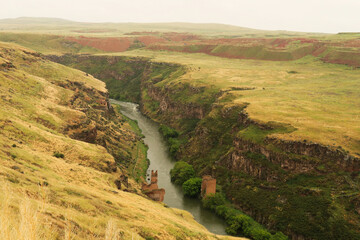 The destroyed, ruined bridge that was built over the Akhurian River down in the canyon, gorge that...