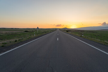 Asphalt road at sunset, travel concept