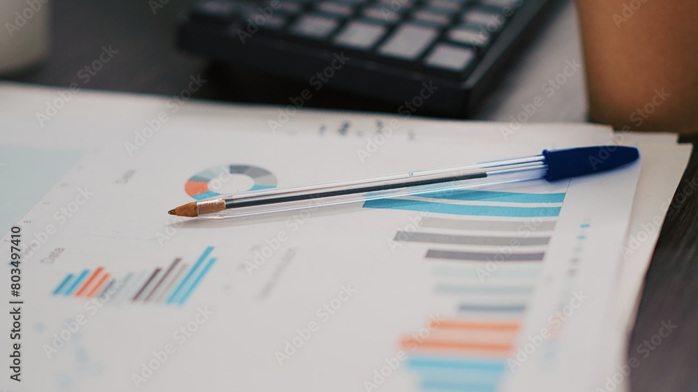 Poster computer keyboard and business graphs and figures on paperwork files showing profits. economic annua