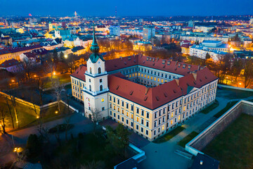 Aerial view of Renaissance building of Rzeszow castle on background of lighted cityscape at...