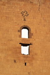 Cross symbol and two windows on the back of the tower next to the Lion Gate at the ancient site of...