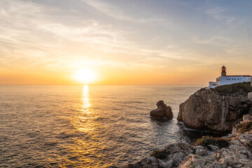 Farol do Cabo de Sao Vincente in Sagres in the Algarve Portugal. Overlooking the blue sea during a beautiful golden sunset