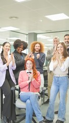 Office team applauding with joy.