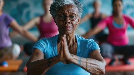 Focused diverse seniors exercising in pilates class with female coach