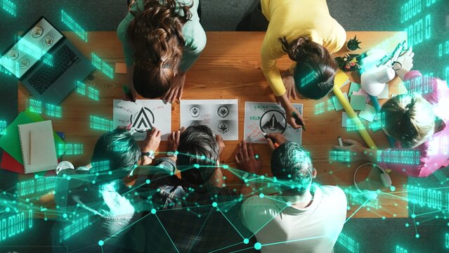 Top view of skilled business team put graphic logo on meeting table with colorful sticky notes and start to design while explain idea. Smart project manager explain about financial graph. Symposium.