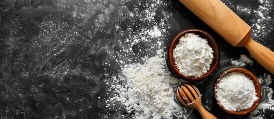Baking setting with available space for your text. Rolling pin and flour on dark surface. Blank area for writing. Overhead view. - Powered by Adobe