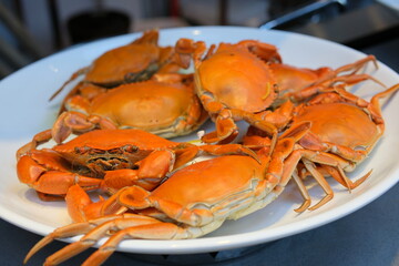 Delicious snow crab leg clusters on a rustic wood table top.