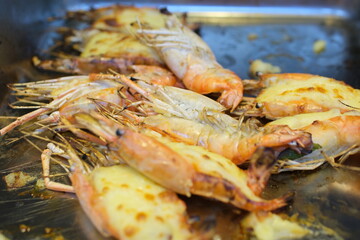 shrimp baked with cheese Delicious grilled lobsters and cheese on white plate