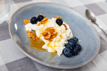 Delicious mato cheese with honey walnuts and blueberries served for dessert