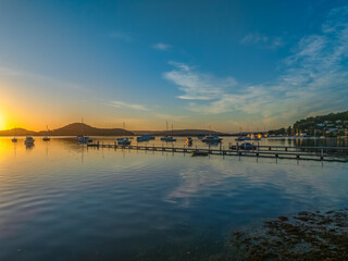 Aerial drone sunrise waterscape over the bay and boats