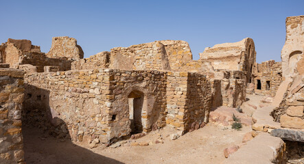 View of old Ksar Beni Barka settlement with ruined storage areas in Tunisia