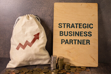 Strategic business partner text on paper on the chart background with pen