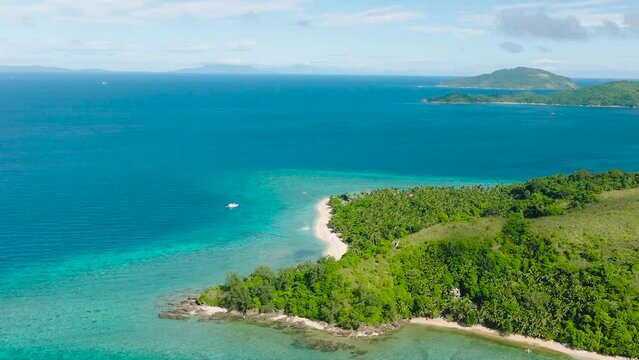 Tropical beach with greenish sea water and corals. Logbon Island. Romblon, Romblon. Philippines.