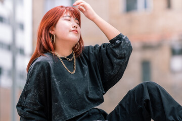 Red-haired Korean woman exudes urban elegance, enjoying a leisurely day