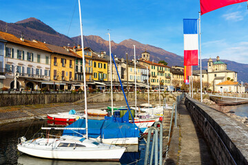 Houses and boats on embankment along shore of Lake Maggiore, Cannobio, Italy.
