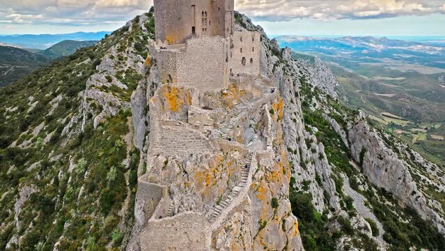 Aerial view of castle ruins perched on a craggy outcrop, with panoramic views from its tower terrace in France.
High fortress on the southern ridge of the Corbi&egrave;res, Ch&acirc;teau de Qu&eacute;ribus.