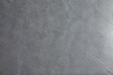 Grey concrete textured surface as background, closeup