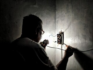  An electrician is repairing an MCB or Miniature Circuit Breaker which functions as a protection...