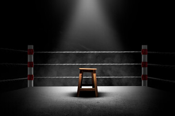 An empty seat in the middle of a boxing ring
