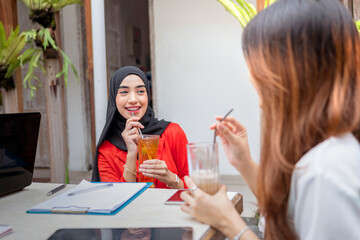 Group of multiracial business people, colleagues coworkers talking, communication, sharing ideas in a lunch meeting at cafe.