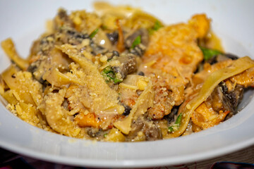 Fettuccine noodles in white sauce with mushrooms and chicken