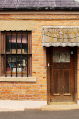 Detail of house front door with an old weathered canvas awning