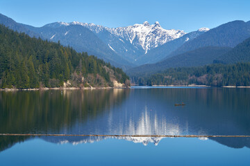 Capilano Lake Lions Peaks Reflection North Vancouver. The view of the Lions high over the Capilano...