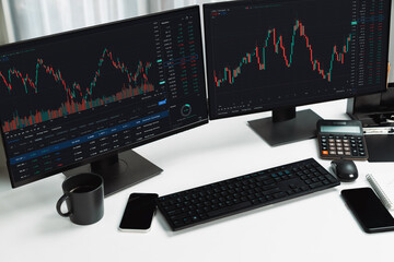 Two screens of dynamic stock market exchange graph showing on computer. Automatically trading sell...