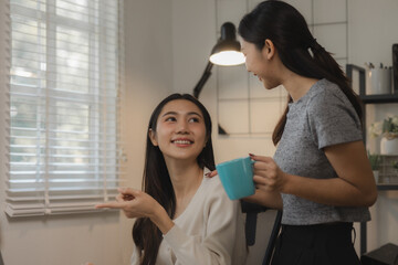 two women entrepreneurs are working together in their home office, business woman is talking to her...