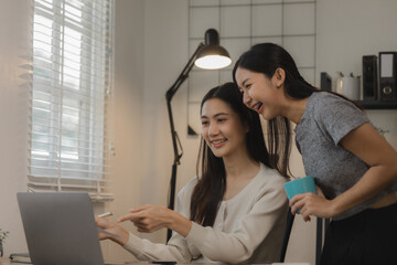 two women entrepreneurs are working together in their home office, business woman is talking to her...